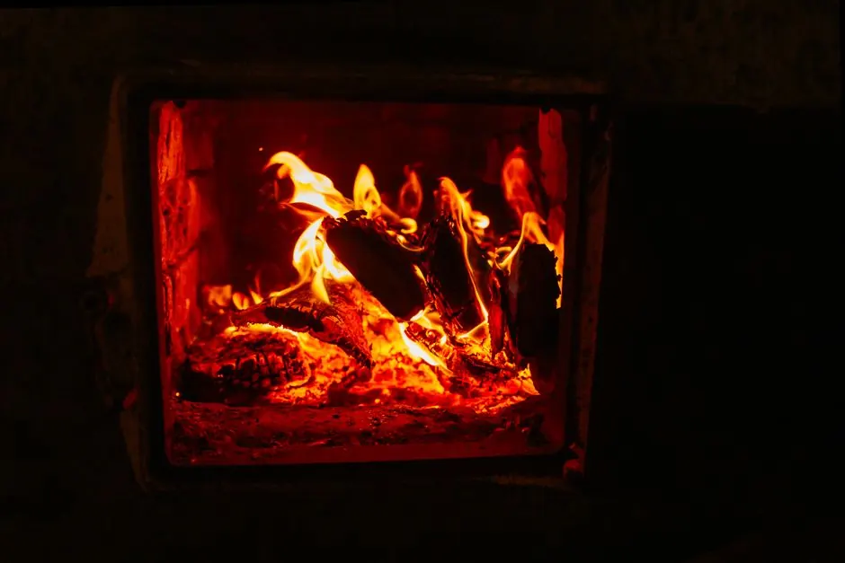 Warm indoor fireplace with crackling firewood and vivid flames creating a cozy atmosphere.
